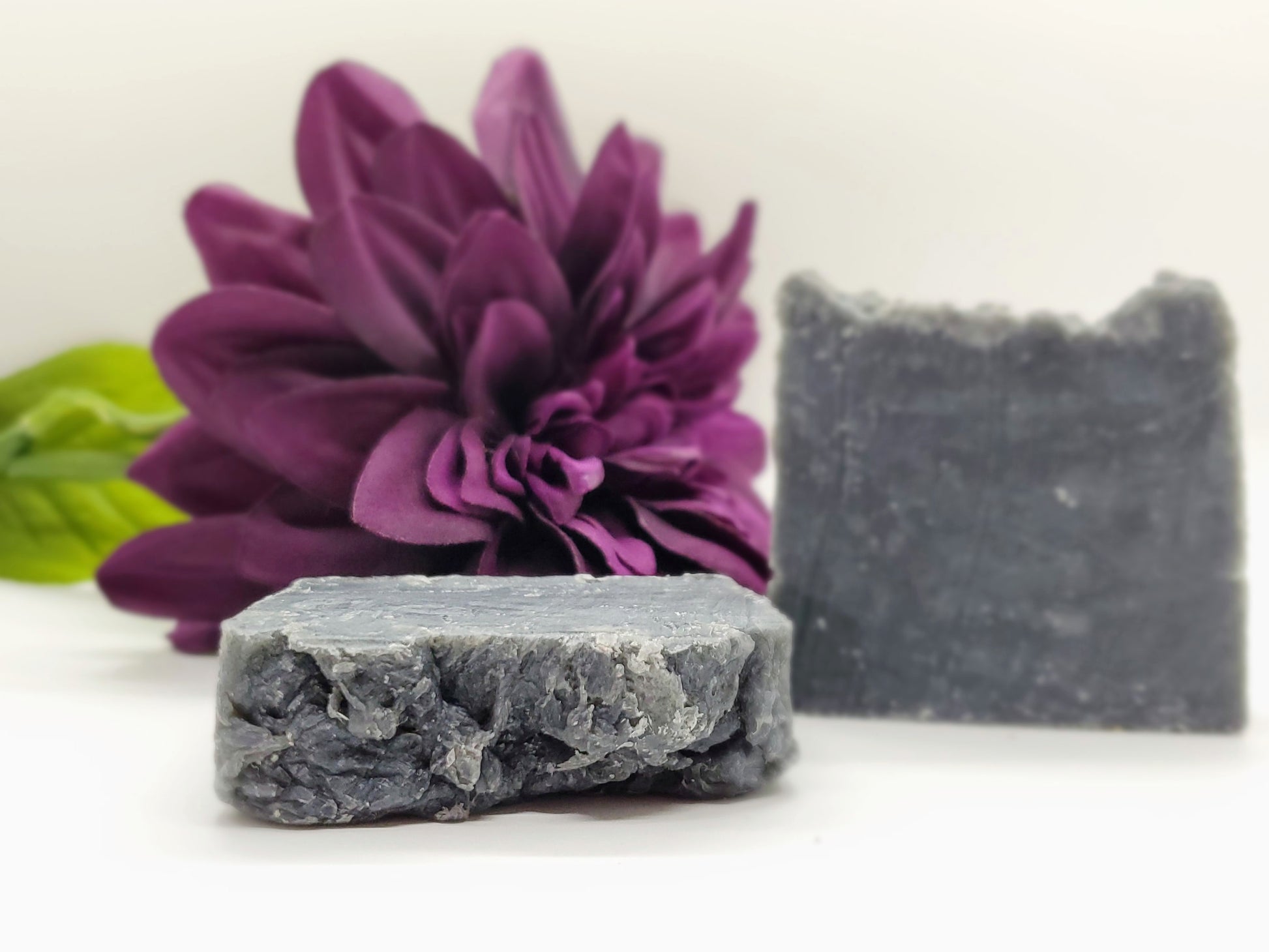 Our soap designs and fragrances are made with natural colorants and pure essential oils. Naturally pigmented with Organic Activated Charcoal. Scented with an invigorating blend of tea tree, rosemary, peppermint, and lavender essential oils.  Great facial bar and good for ally skin types.  Aides in acne, blemish, pore size reduction.  Draws out impurities.  Cruelty free. 