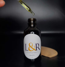 Load image into Gallery viewer, L&amp;R Beard oil (2oz)  cares for your beard and underlying skin. Helps the manageability of your beard and adds moisture naturally.  Made with jojoba oil, sweet almond oil, and an refreshing essential oil blend .  Great for all skin and hair types. Choose from our 4 premium essential oil blends (unscented available). Best used with wooden beard comb.
