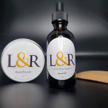 Load image into Gallery viewer, L&amp;R Beard oil (2oz)  cares for your beard and underlying skin. Helps the manageability of your beard and adds moisture naturally.  Made with jojoba oil, sweet almond oil, and an refreshing essential oil blend .  Great for all skin and hair types. Choose from our 4 premium essential oil blends (unscented available). Best used with wooden beard comb.
