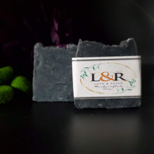 Load image into Gallery viewer, Our soap designs and fragrances are made with natural colorants and pure essential oils. Naturally pigmented with Organic Activated Charcoal. Scented with an invigorating blend of tea tree, rosemary, peppermint, and lavender essential oils.  Great facial bar and good for ally skin types.  Aides in acne, blemish, pore size reduction.  Draws out impurities.  Cruelty free. 
