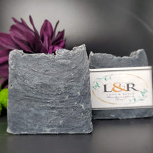 Load image into Gallery viewer, Our soap designs and fragrances are made with natural colorants and pure essential oils. Naturally pigmented with Organic Activated Charcoal. Scented with an invigorating blend of tea tree, rosemary, peppermint, and lavender essential oils.  Great facial bar and good for ally skin types.  Aides in acne, blemish, pore size reduction.  Draws out impurities.  Cruelty free. 

